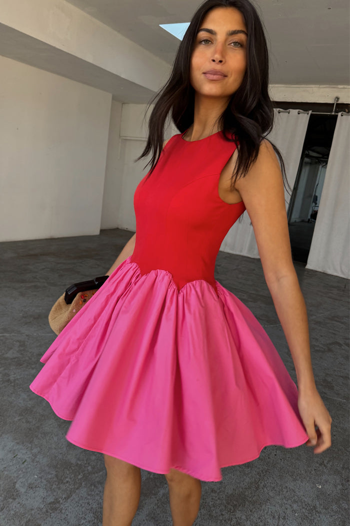 Red and Pink Mini Monika Dress featuring a red panelled top and a pink pleated skirt with scalloped edging.