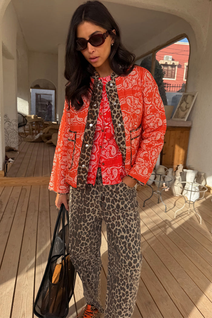 Quilted Red Bandana Reversible Jacket with leopard print trim, paired with leopard print trousers.