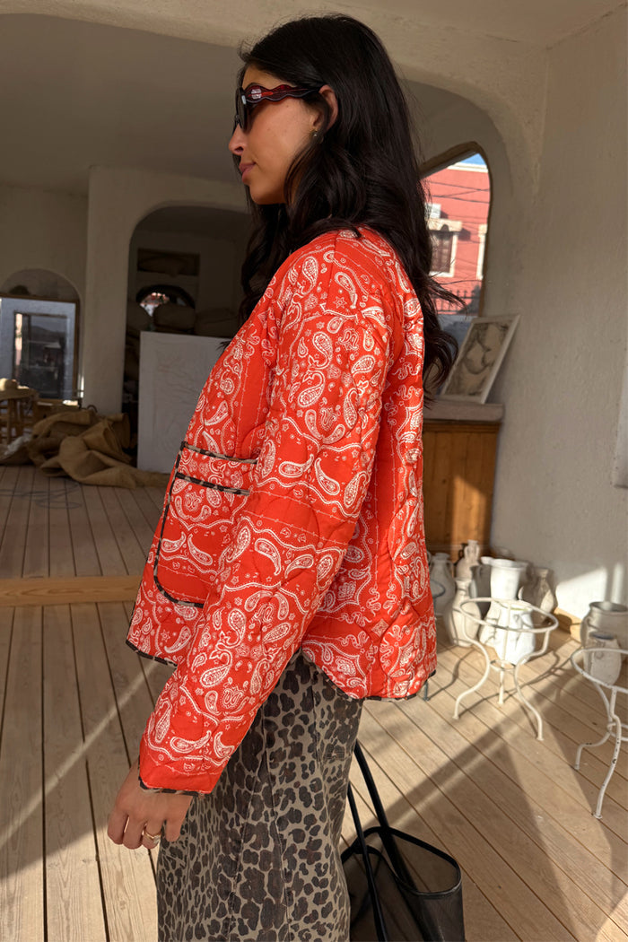 Red Bandana Reversible Jacket featuring a quilted paisley print and leopard trim, paired with leopard print trousers.