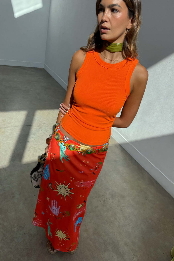 Red Celestial Dorris Satin Skirt with hand-painted motifs, styled with an orange tank top for dopamine dressing.