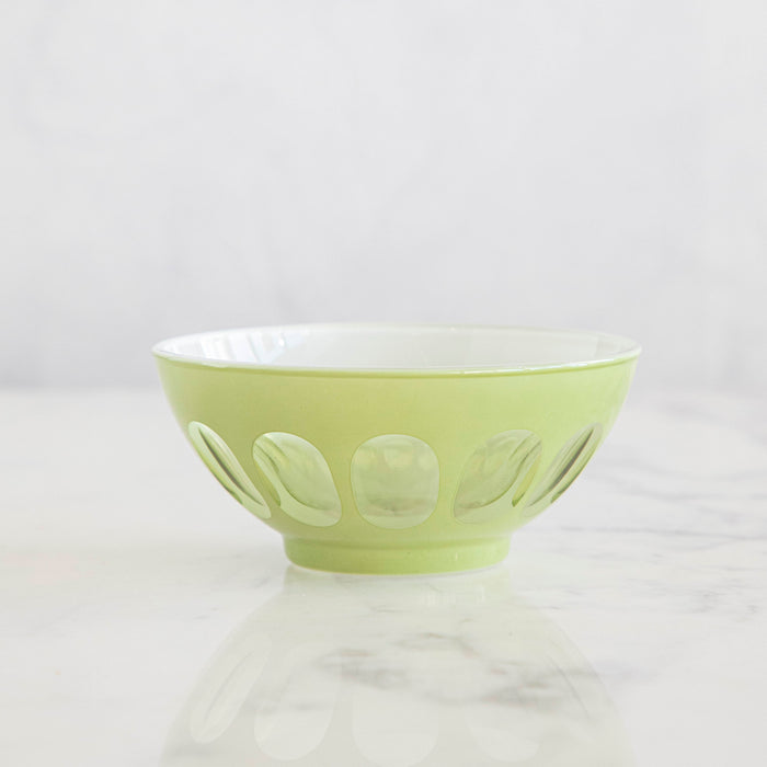 A Rialto Pale Sage Glass Bowl on a marble table.