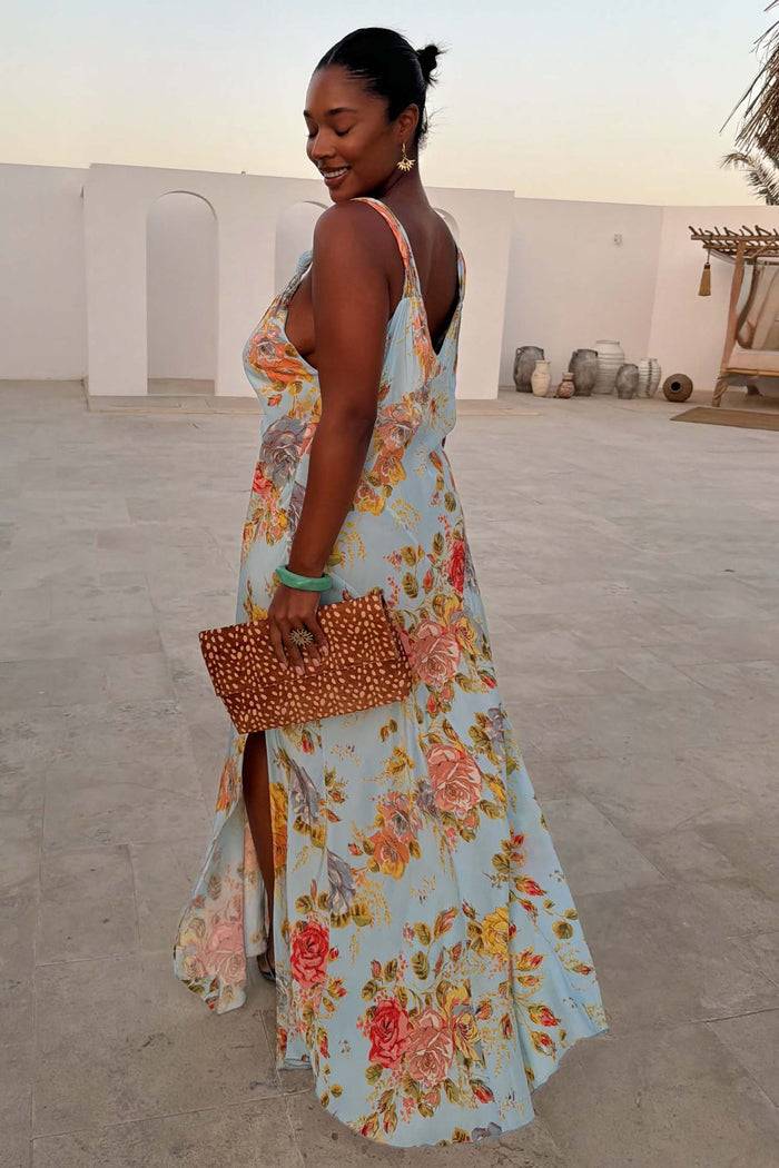 Sky Blue Floral Sofia Dress with a side slit and tie shoulders, shown on a model for inclusive sizing.