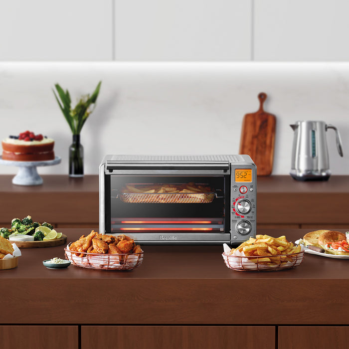 Breville Smart Oven™ Air Fryer Compact with 1507W waffle and toaster functions, shown on a kitchen countertop.
