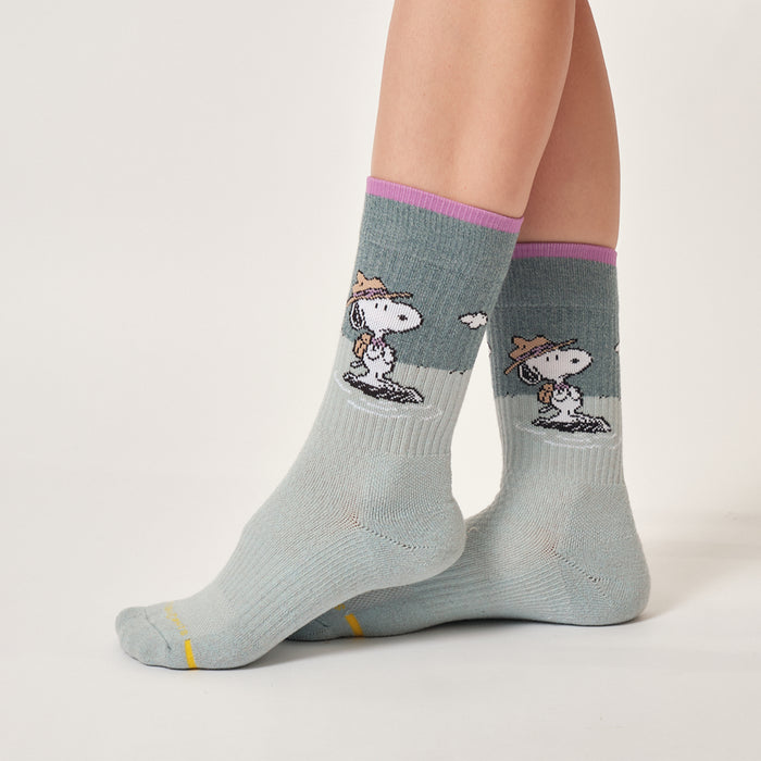 Aqua marl crew compression socks with a Snoopy Beagle Scout design, worn in an outdoor setting.