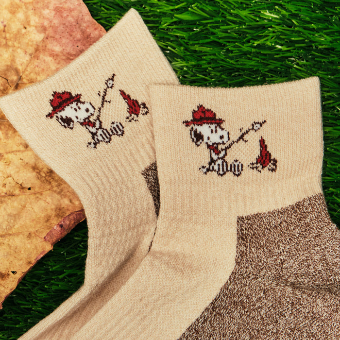 Ivory oat quarter compression socks with a Snoopy campfire design, shown flat.