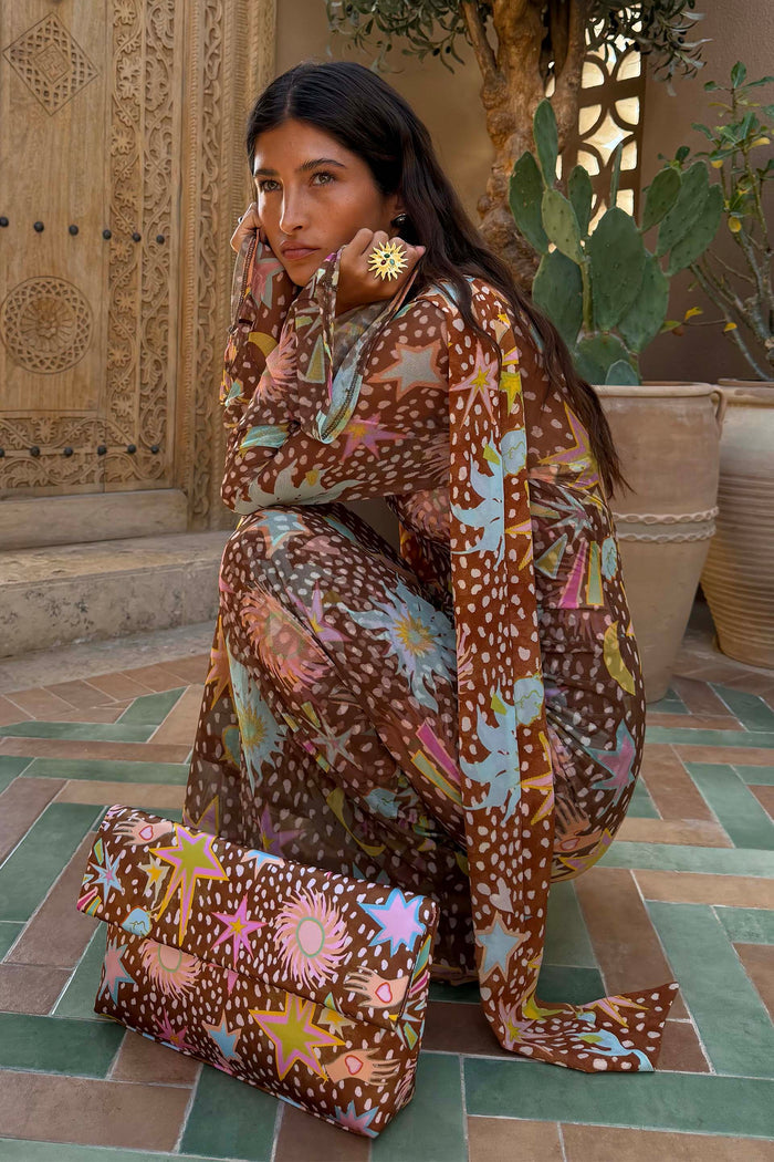 Brown Star Fawn Aria Mesh Dress featuring fawn spots and sun motifs, paired with a matching printed clutch bag.