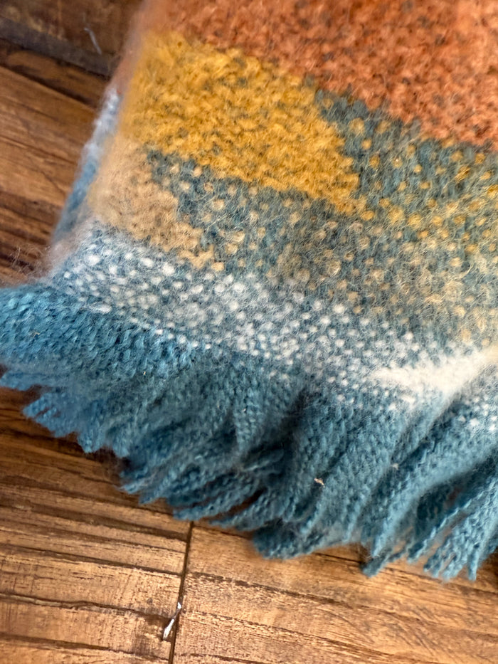 Oversized throw blanket corner with blue and cream Aztec weave and tasseled fringe