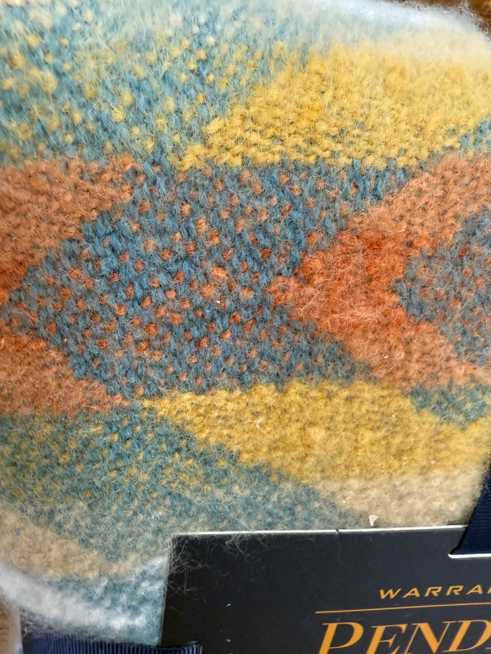 Multicolor woven throw blanket with blue, yellow, orange Aztec pattern close-up