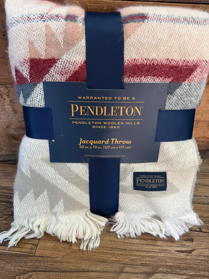 Oversized throw blanket with off-white, red, and blue geometric pattern and fringe