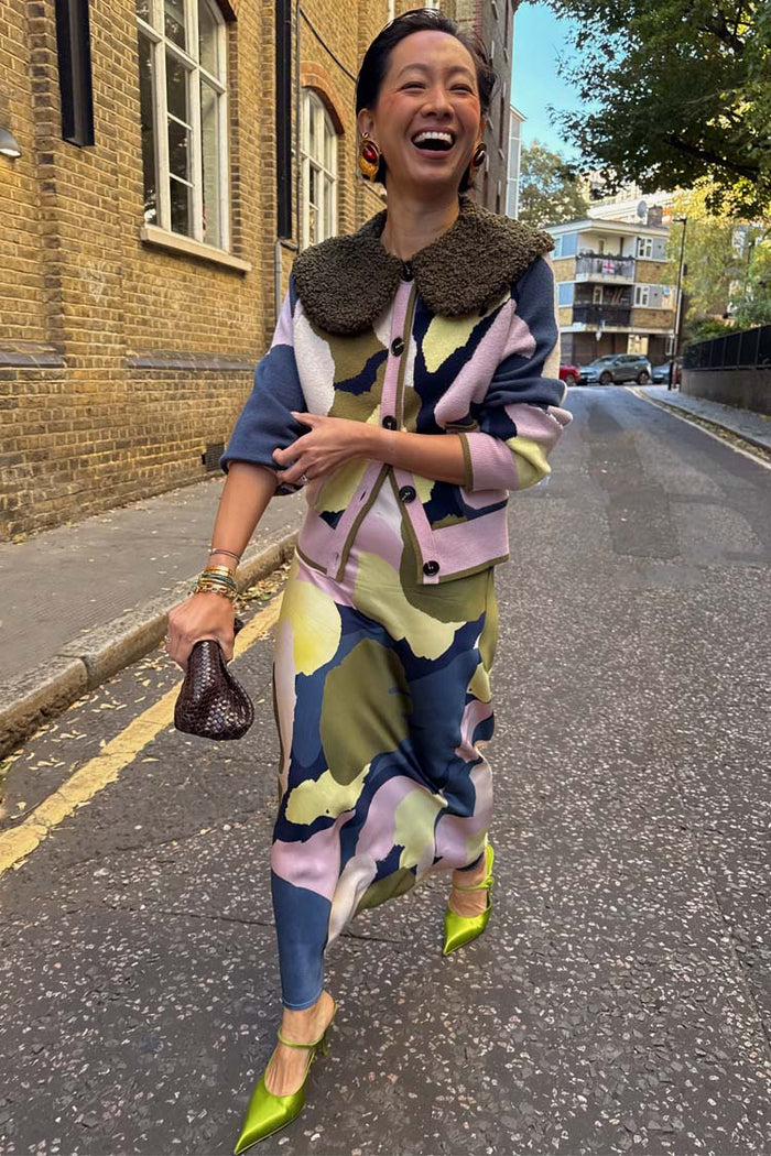 Teal Mara Abstract Dorris Skirt in a hand-painted print, paired with a matching cardigan on a London street.