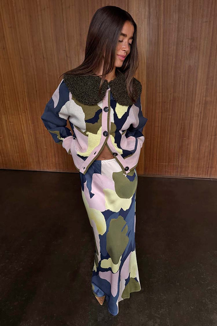 Teal Mara Abstract Dorris Midi Skirt in a neutral-toned print, styled as a transeasonal co-ord with a matching cardigan.
