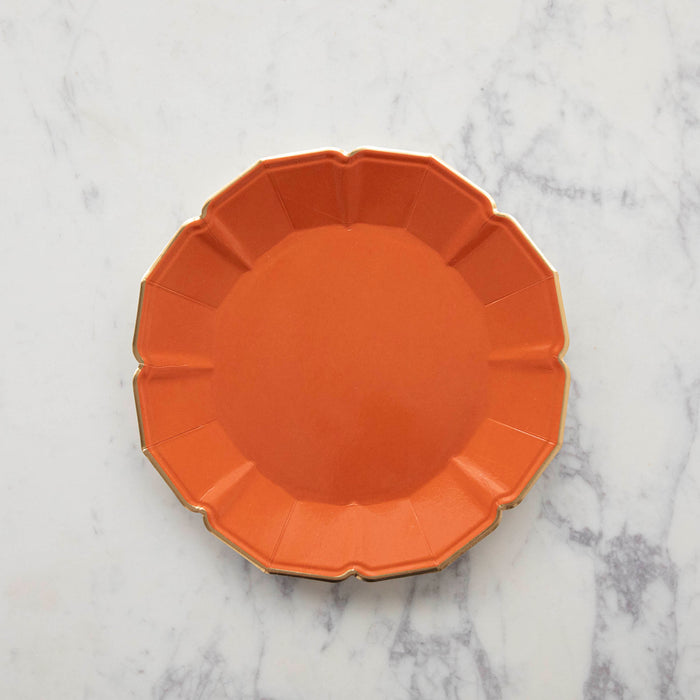 An orange scalloped paper plate.