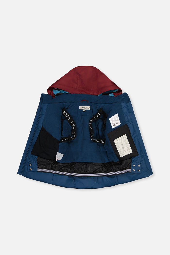 Blue TEKNIK jacket open to show the fleece lining and backpack straps