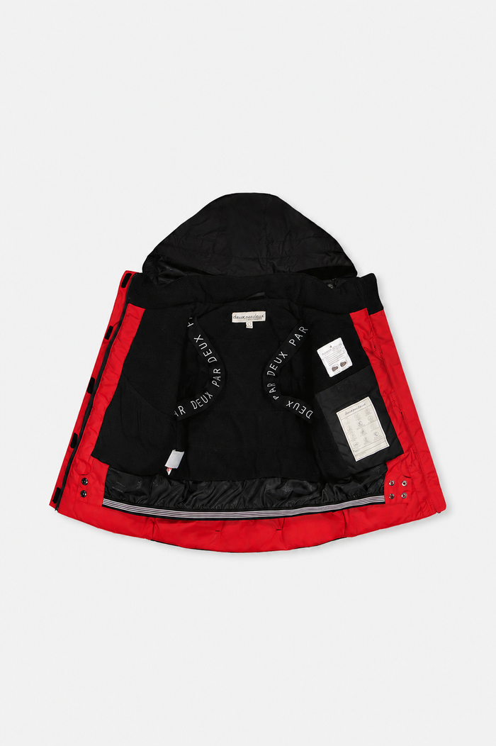 Red and black TEKNIK jacket open to show the black fleece lining and backpack straps