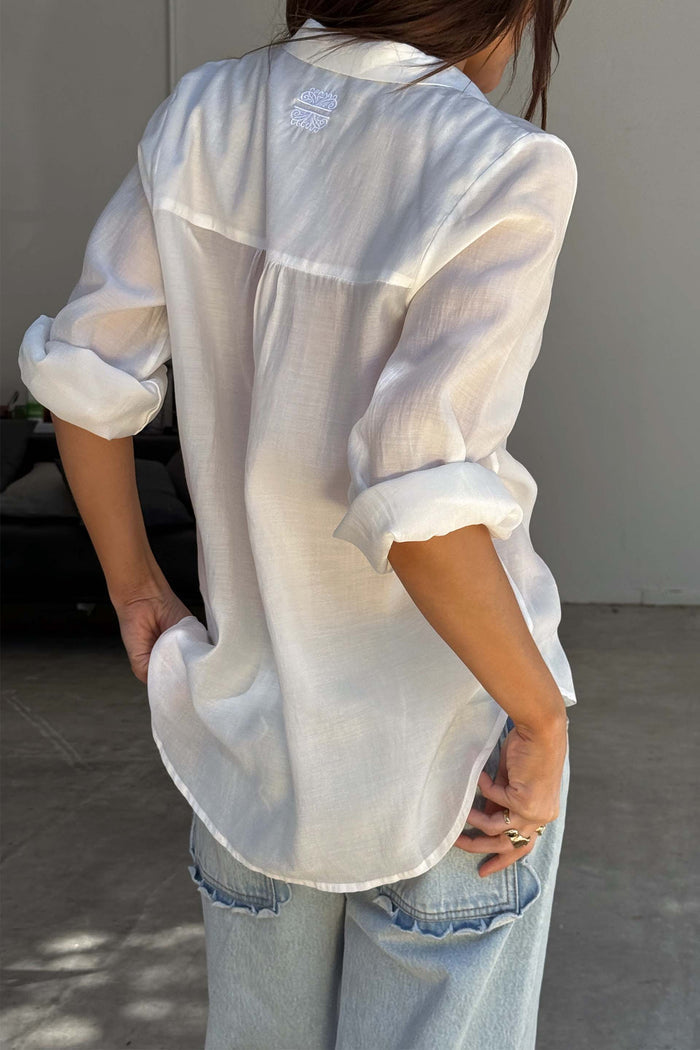 White Miley Shirt with embroidered back neck logo and rolled sleeves, showing its lightweight, oversized fit.
